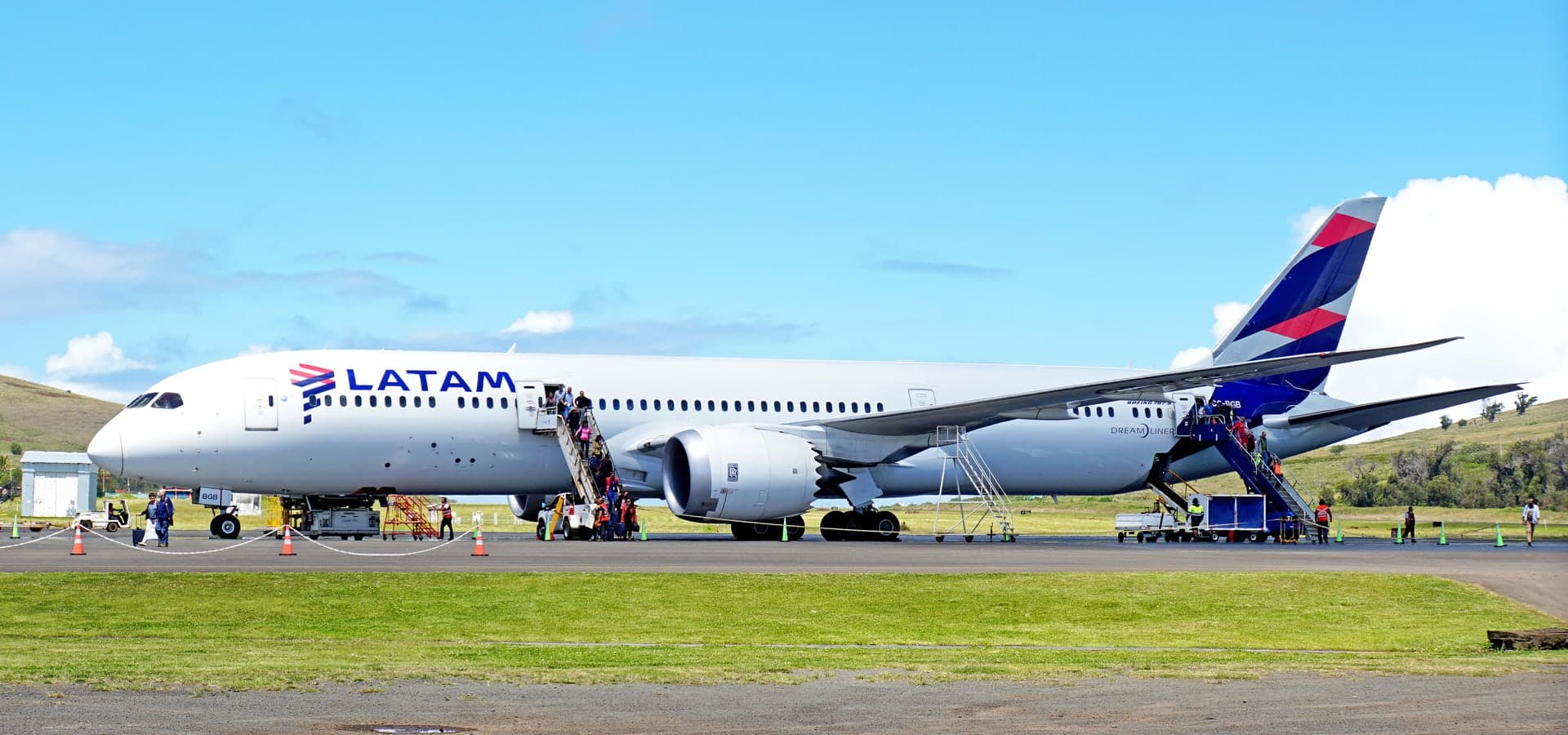 Aircraft in flight above clouds, suggesting the journey to a remote island.